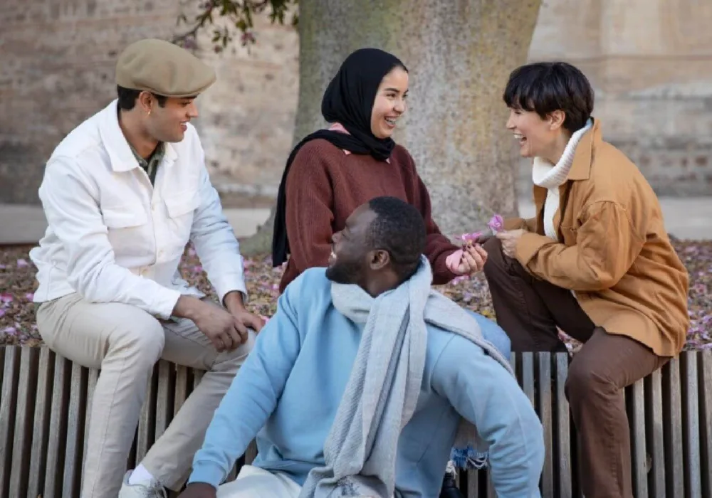 Youth chatting outside on a bench