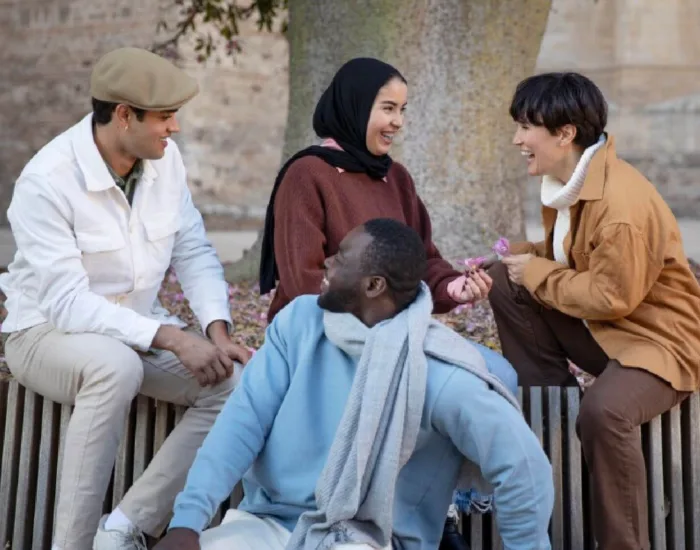 Youth chatting outside on a bench
